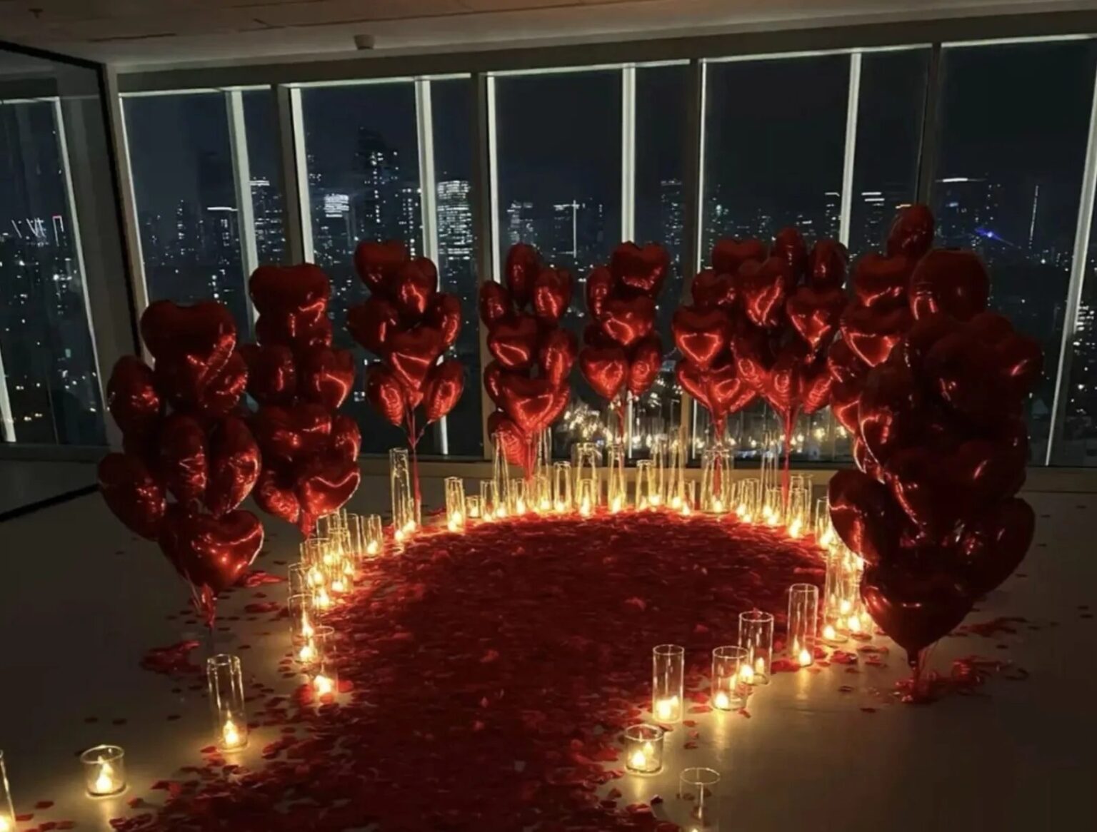 A heart of rose petals and candles for a proposal, The Wedding Atelier