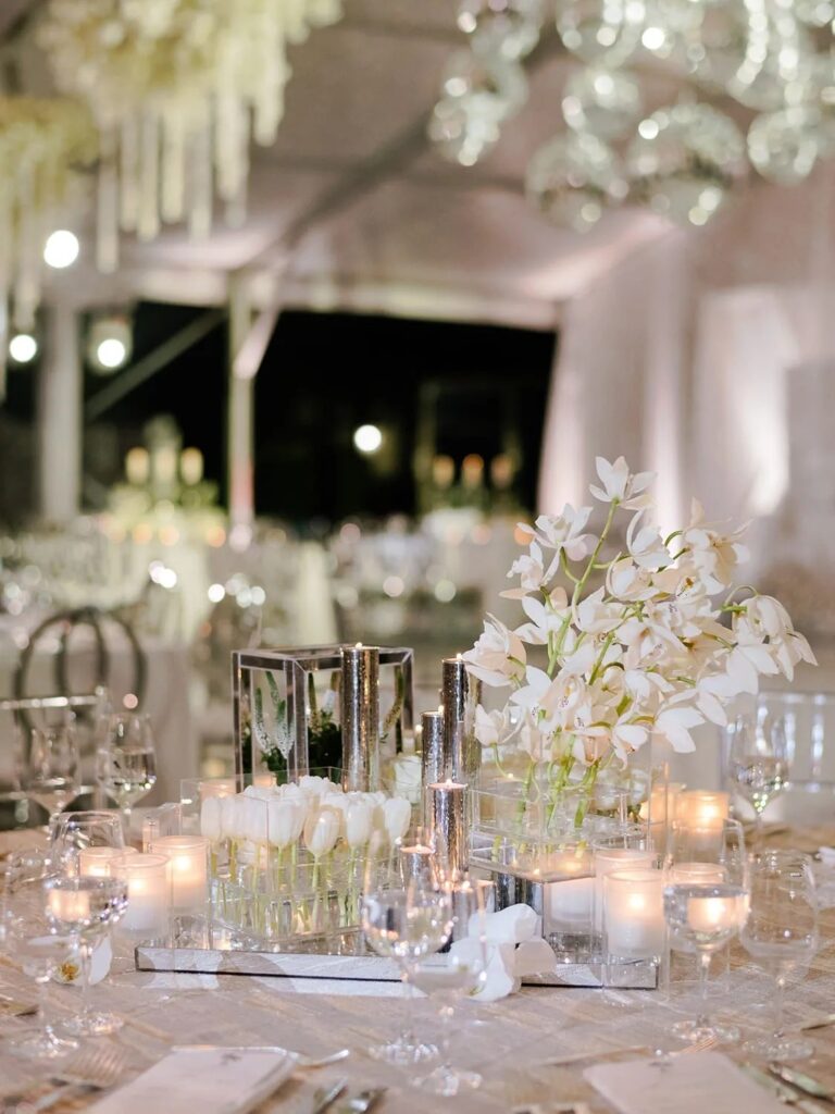 A tent interior set with candles and flowers, The Wedding Atelier