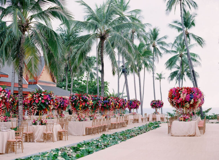 A pink and orange flower aisle leading to Thai-style pavilions among palms, The Wedding Bliss - Thailand