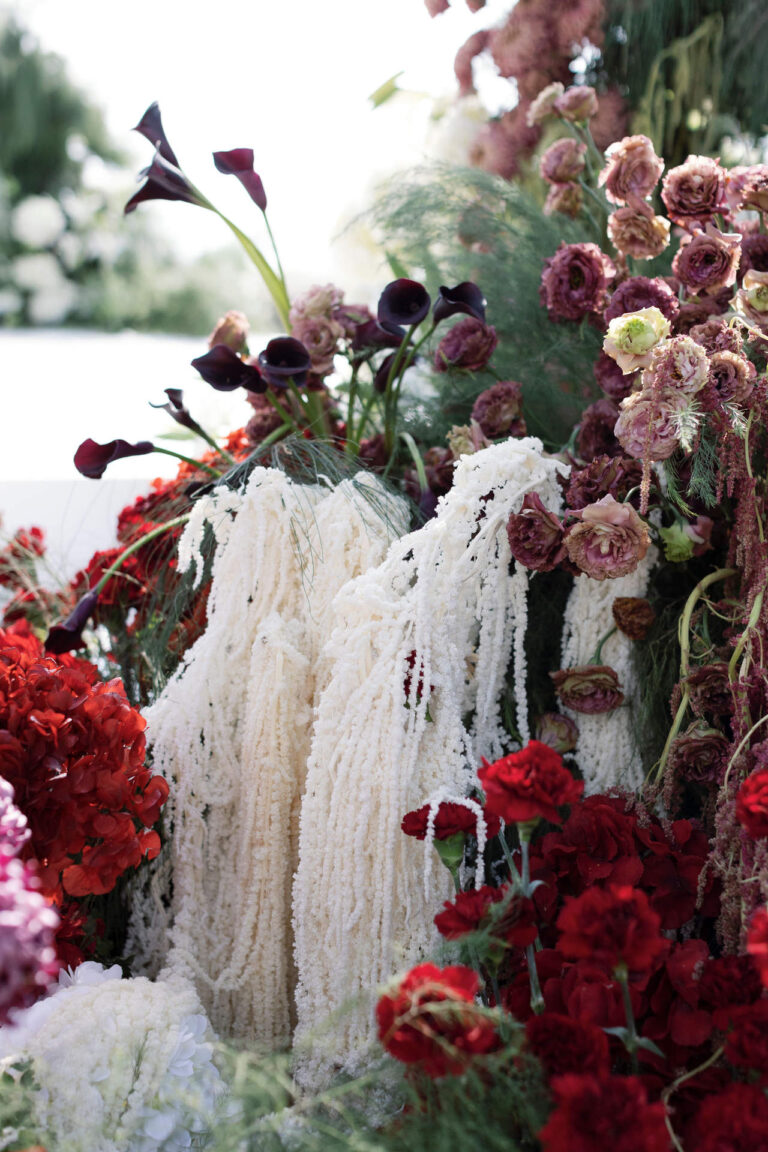 A wall of deep red flowers, white amaranthus and dark calla lilies, The Wedding Bliss - Thailand