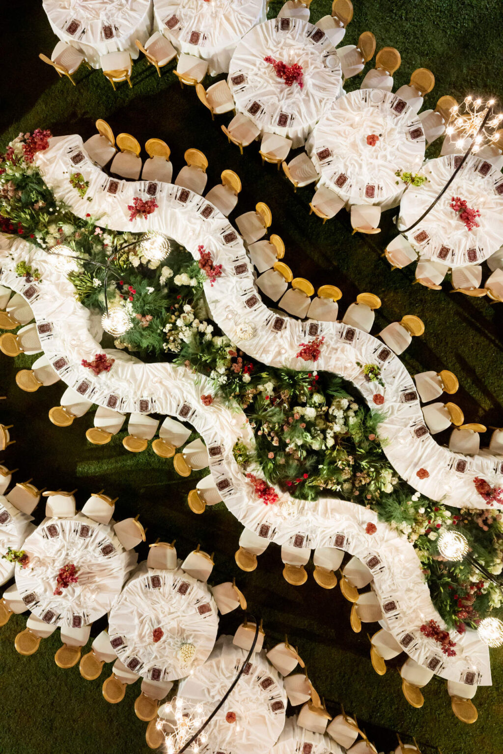 Serpentine tables of white linen and flowers seen from directly above, The Wedding Bliss - Thailand