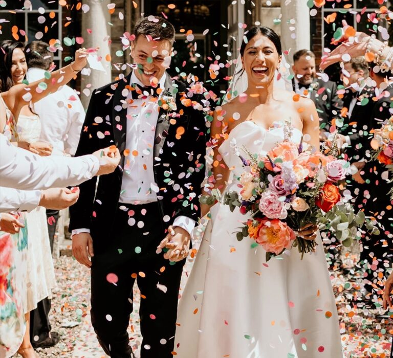 Nancy and Arthur walking through confetti, The Wedding Shop