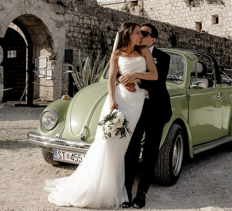 Lynda and Jonathan with a vintage car at their destination wedding, The Wedding Shop