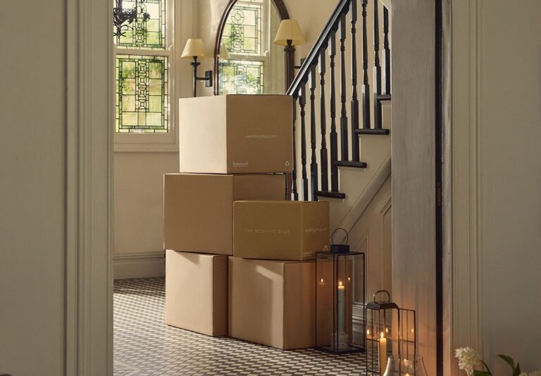 Wedding gifts delivered to a home, stacked in boxes by the stairs, The Wedding Shop