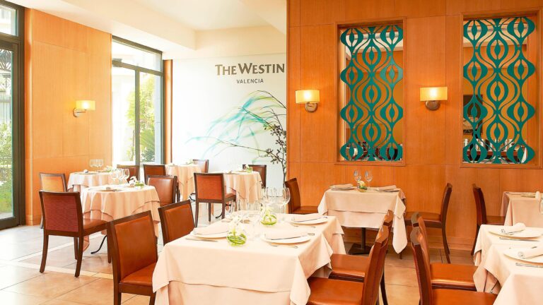 The Rosmarino dining room, white-clothed tables and Modernista-inspired panelling, The Westin Valencia
