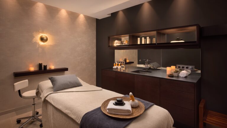 A candlelit spa treatment room, warm woods and soft light, The Westin Valencia