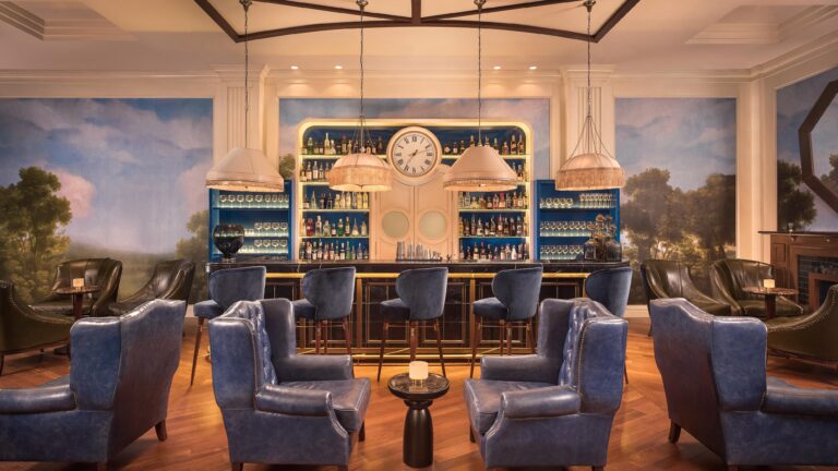 The bar lounge, painted landscape murals, wing chairs and a backlit spirits shelf, The Westin Valencia