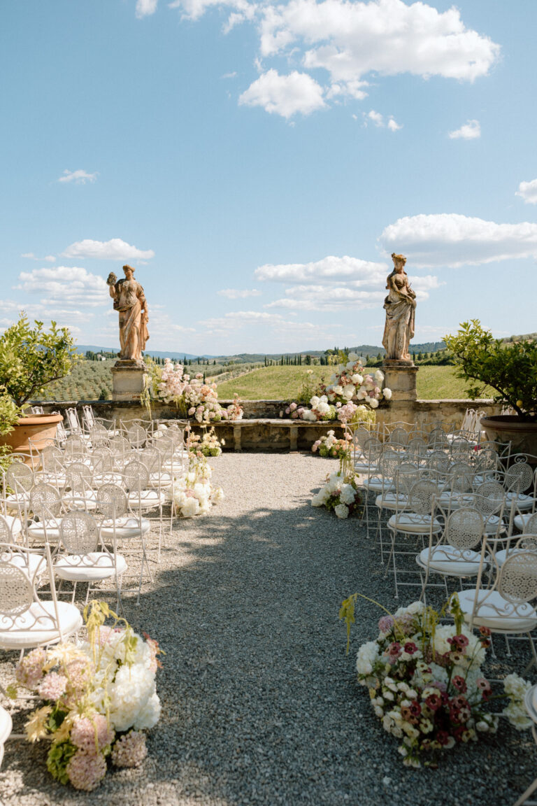 Ceremony aisle lined with flowers between the terrace statues, Villa Corsini a Mezzomonte, TheKnotInItaly