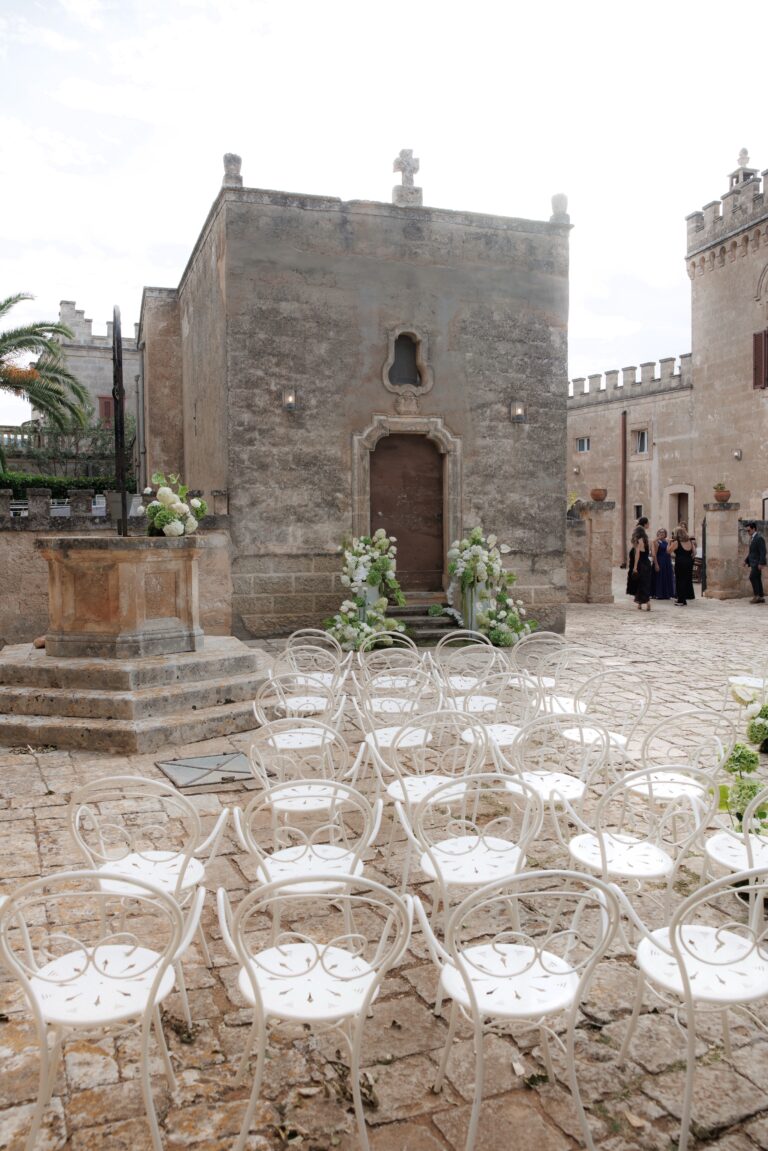Ceremony chairs set in the stone courtyard of Masseria Salamina, Puglia, for Kierstin and Peter, TheKnotInItaly