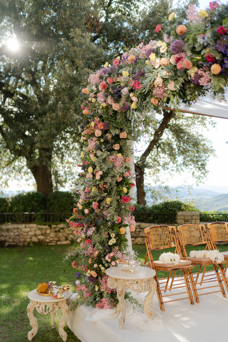 Floral arch over the ceremony space at Borgo Pignano, Tuscany, TheKnotInItaly