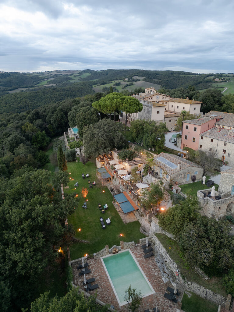 Aerial view of Borgo Pignano and its gardens in the Tuscan hills during the wedding, TheKnotInItaly
