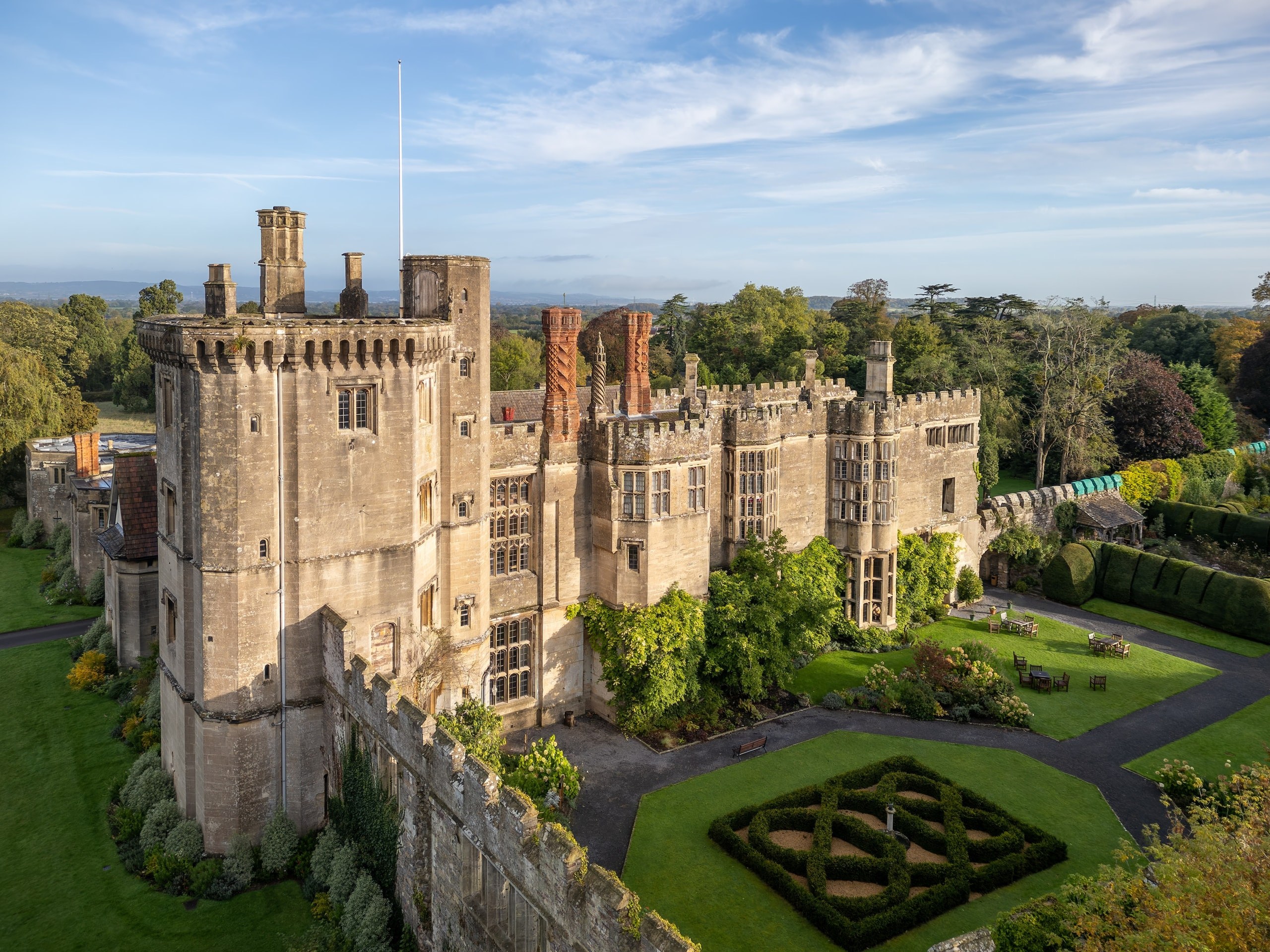 Aerial view of the castle tower, battlements and the clipped knot garden inside the walls, Thornbury Castle