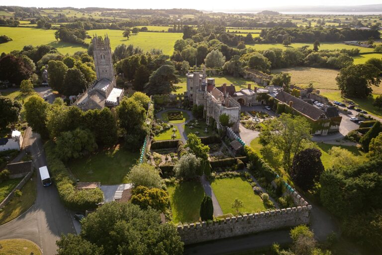 The castle, St Mary's Church and the walled gardens from above, with farmland running towards the Severn, Thornbury Castle