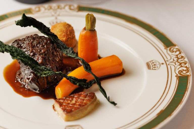 A main course of beef with carrots and kale on the castle's crested china, Thornbury Castle