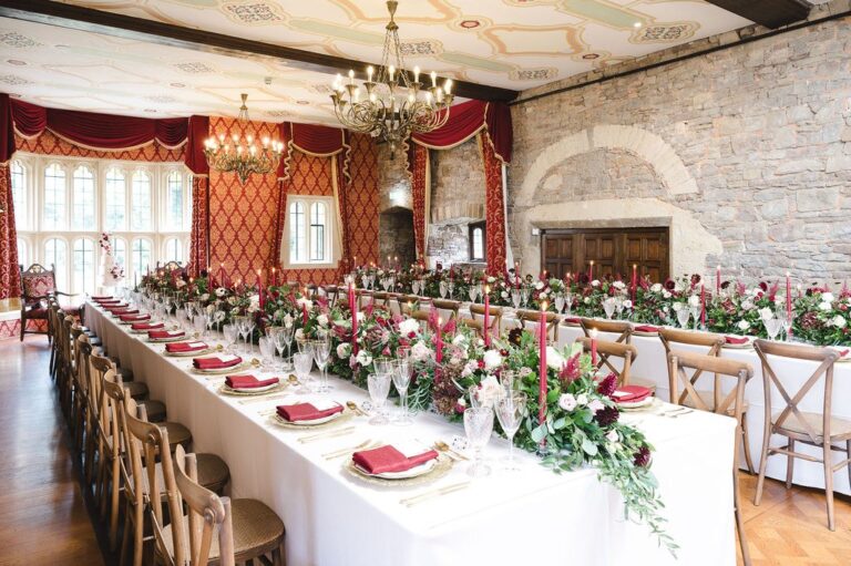 A long banqueting table dressed with flowers under the Tudor Hall chandeliers, Thornbury Castle