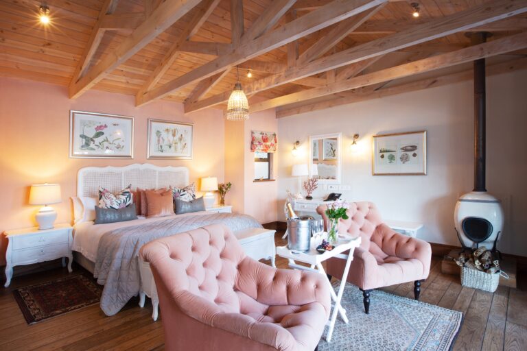 The Saint Marie Island Suite, pink tufted chaise and chandelier, Tintswalo Atlantic