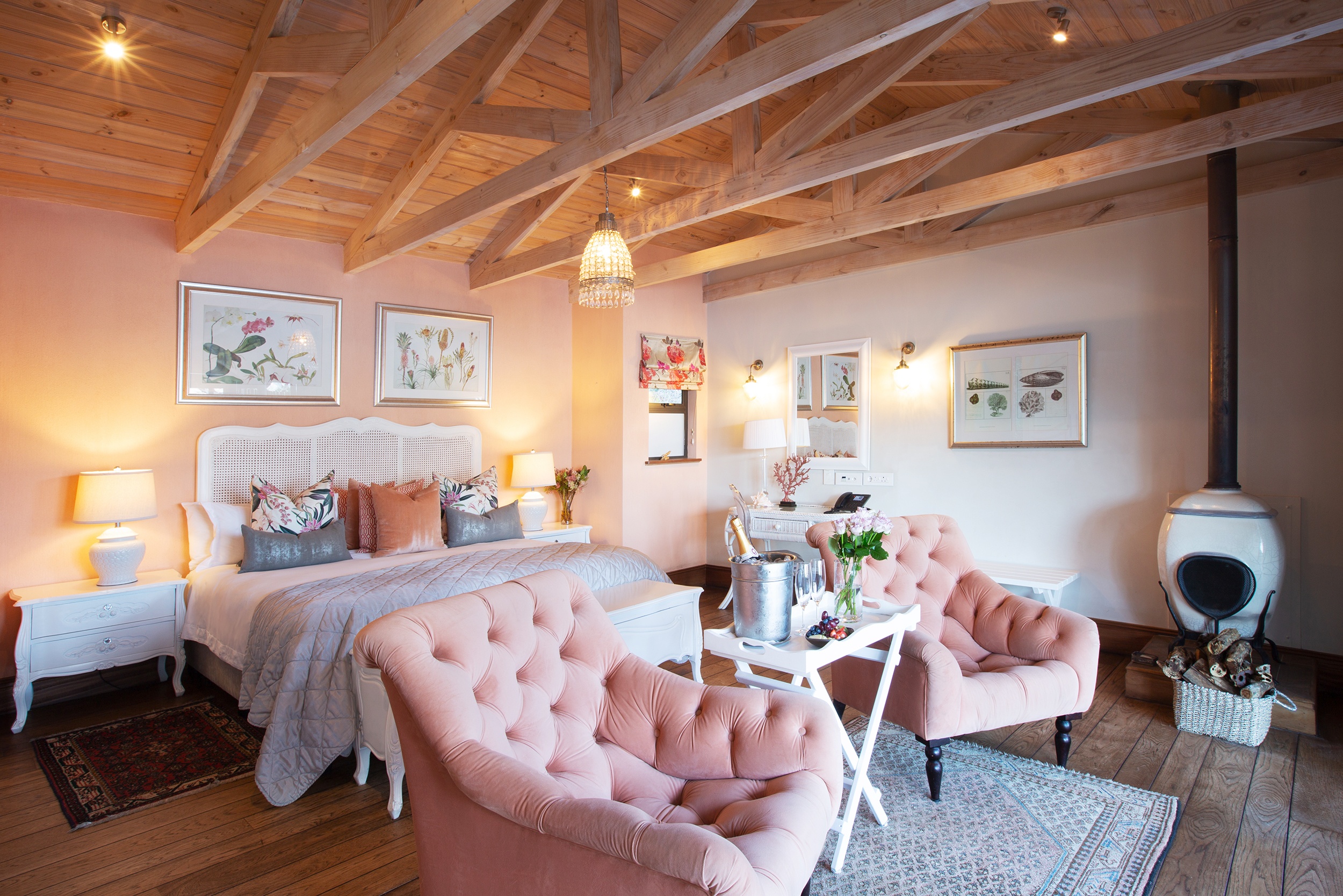 The Saint Marie Island Suite, pink tufted chaise and chandelier, Tintswalo Atlantic