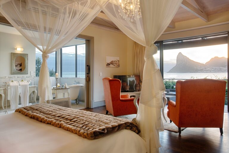 The Corsica Mountain Suite, a four-poster under mosquito net, sea through the glass, Tintswalo Atlantic