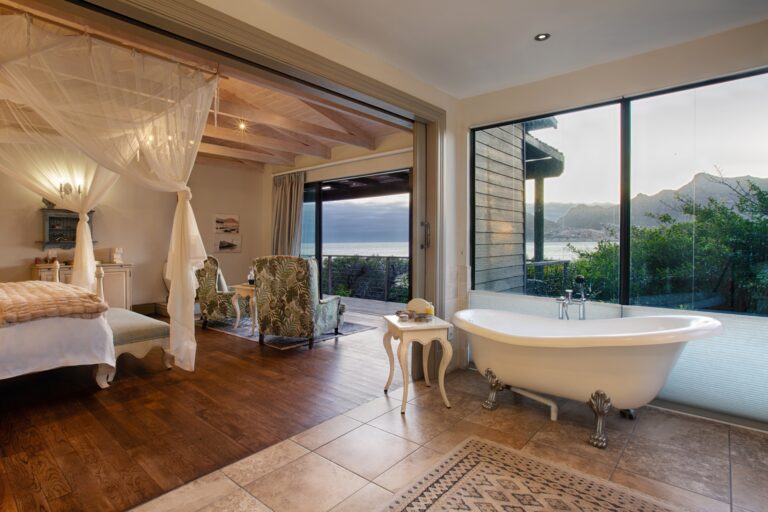 The Elba Mountain Suite, a freestanding clawfoot bath, folding doors to the ocean, Tintswalo Atlantic
