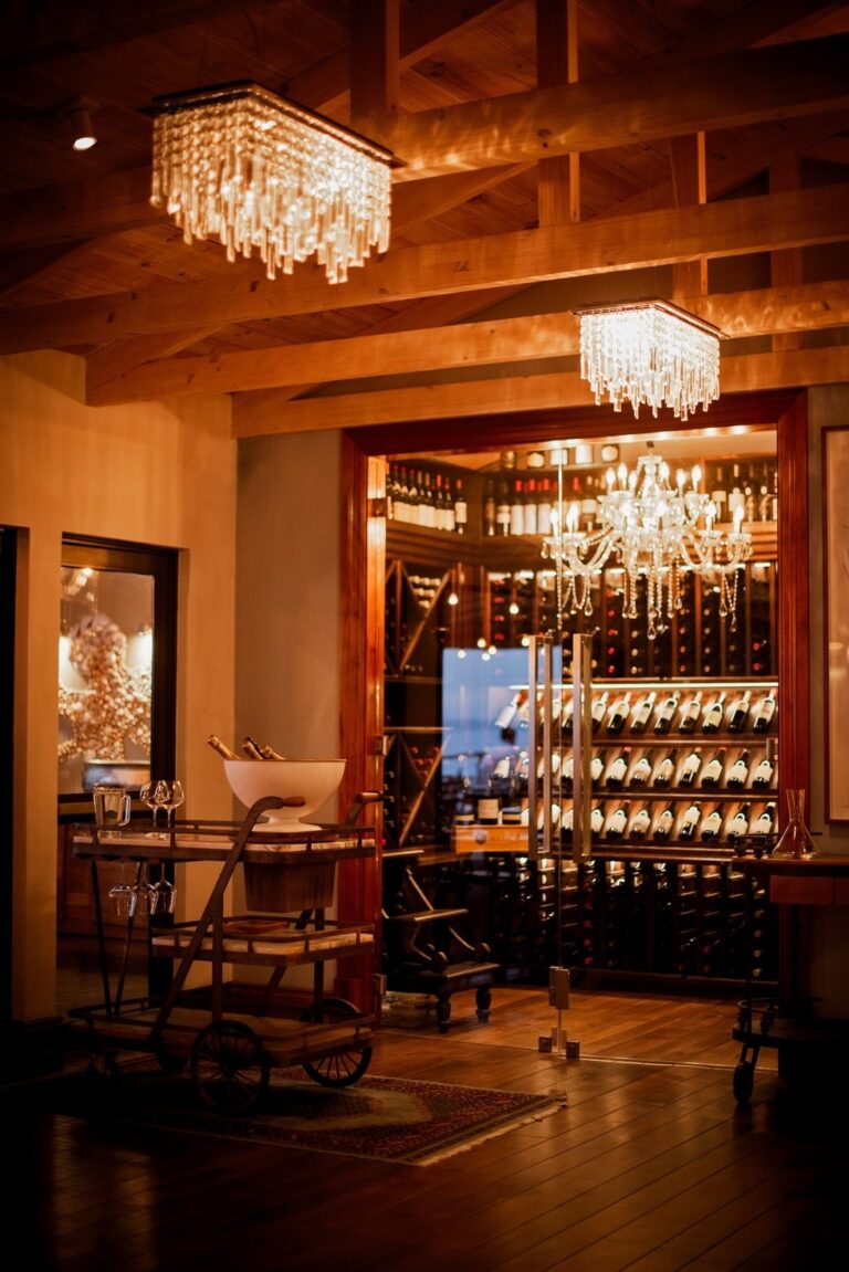 The dining room, chandeliers and a lit wine display, Tintswalo Atlantic