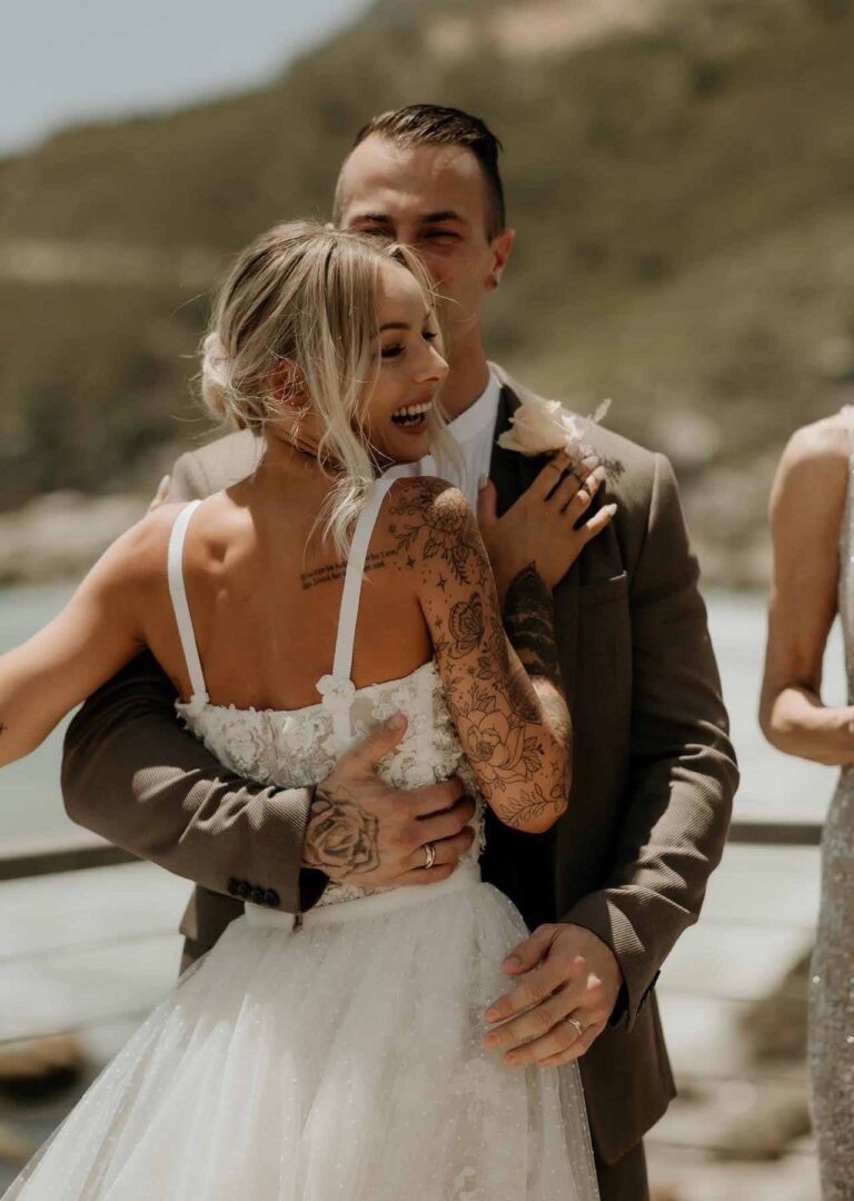The couple embracing, the bride in a strapless gown, Tintswalo Atlantic