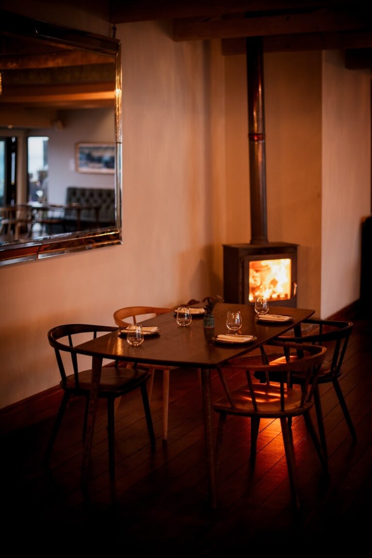 Restaurant table beside the fireplace, Tintswalo Lodges