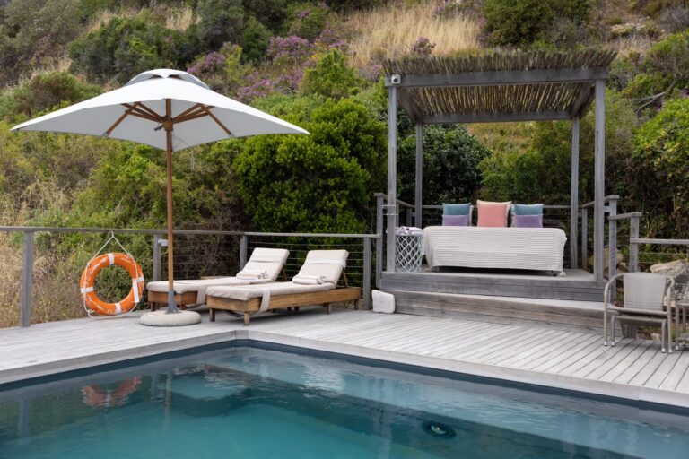 Pool deck with daybed pergola above the Atlantic, Tintswalo Lodges