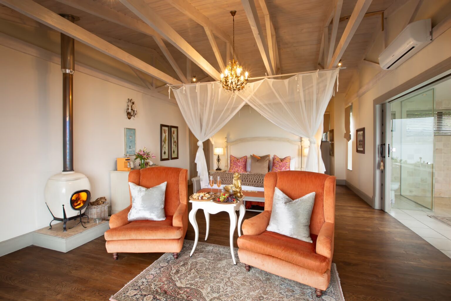 A mountain suite bedroom with a canopy bed and fireplace