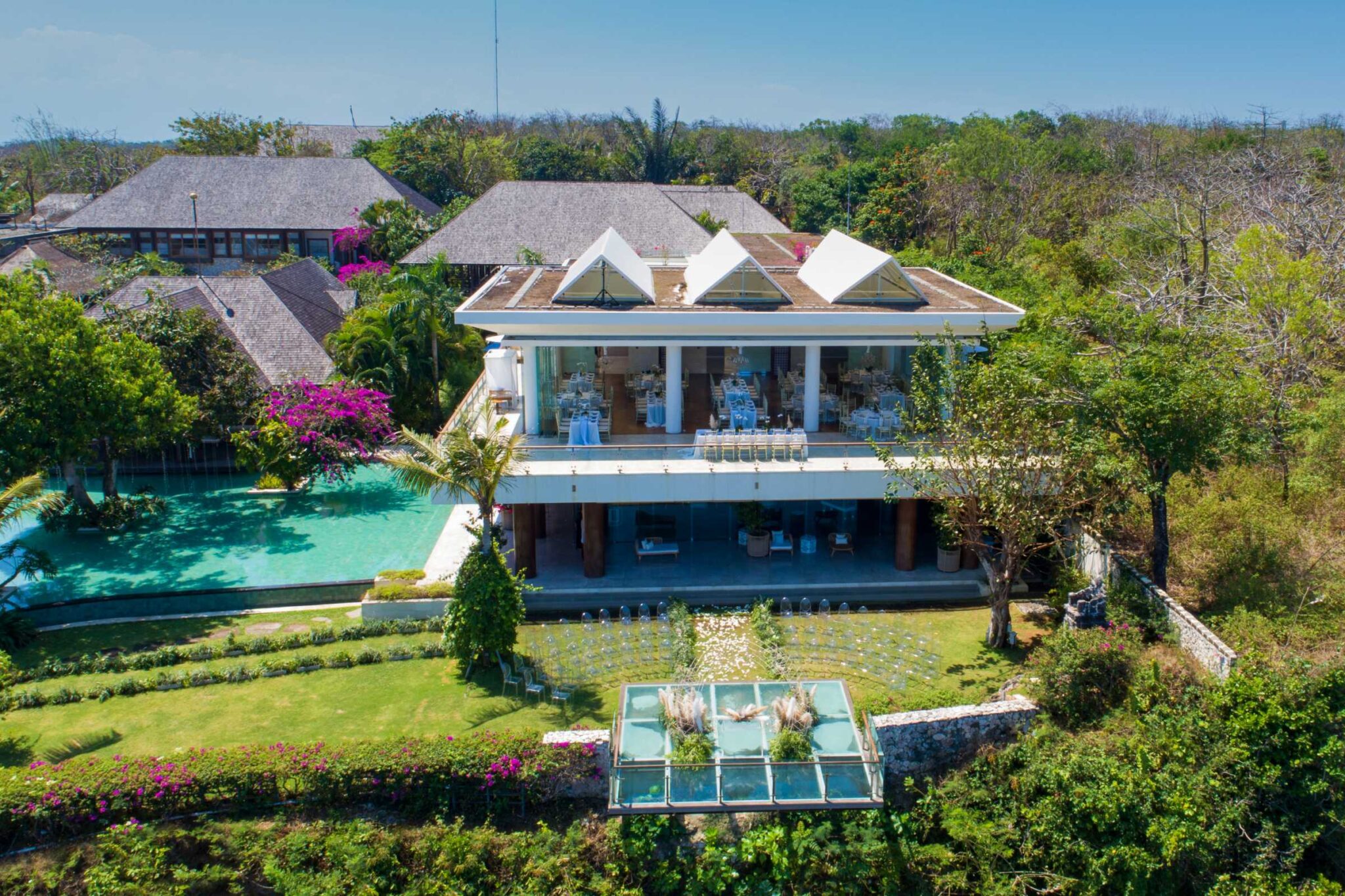 Aerial view of the main building, the Glass Stage and the gardens at Tirtha Uluwatu, Tirtha Bridal
