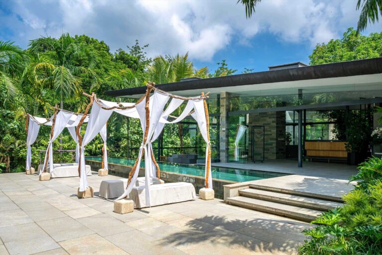 The pool at Glass House by Tirtha with white ceremony canopies, Tirtha Bridal
