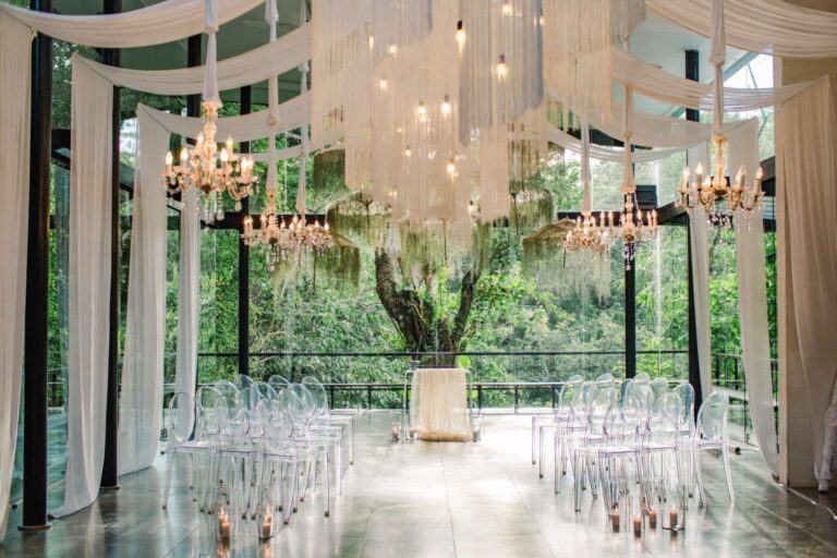 The Plumeria Room with chandeliers and white drapes, Tirtha Bridal