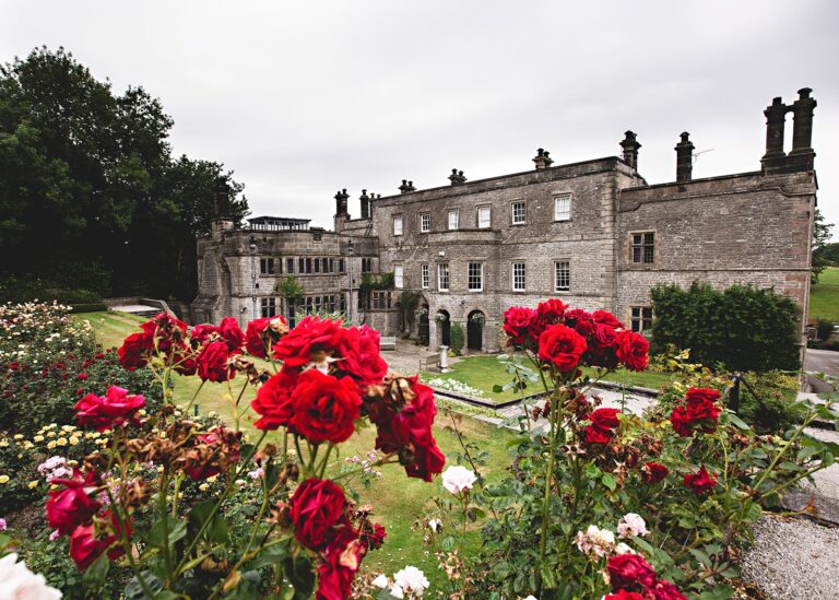 The Jacobean hall rising behind the red rose garden, Tissington Hall
