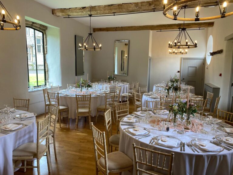 The Carriage House set for dinner, iron chandeliers, Tissington Hall