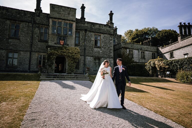 Bride and groom on the gravel drive before the hall, Tissington Hall