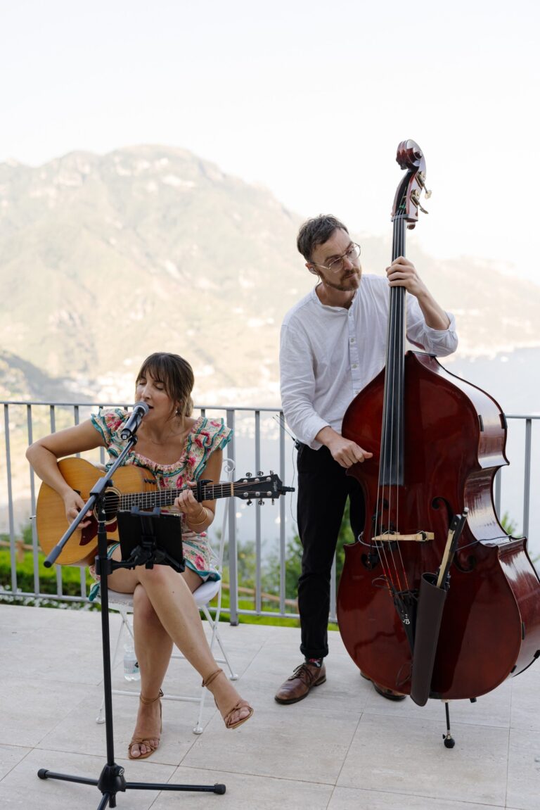Duo playing on a terrace with mountains behind, Tobi Tobi