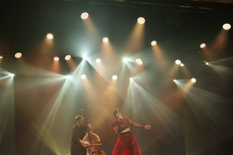 Live event performance under stage lighting, Tobi Tobi