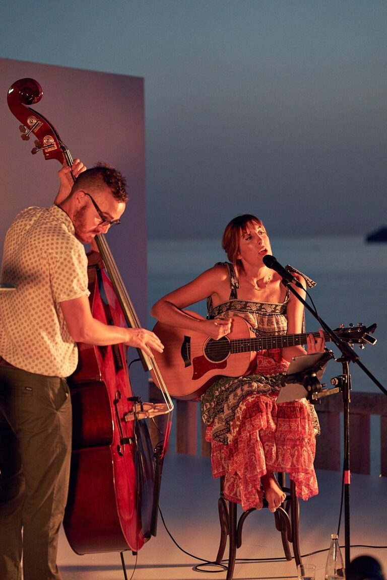 Duo performing at dusk above the sea, Tobi Tobi