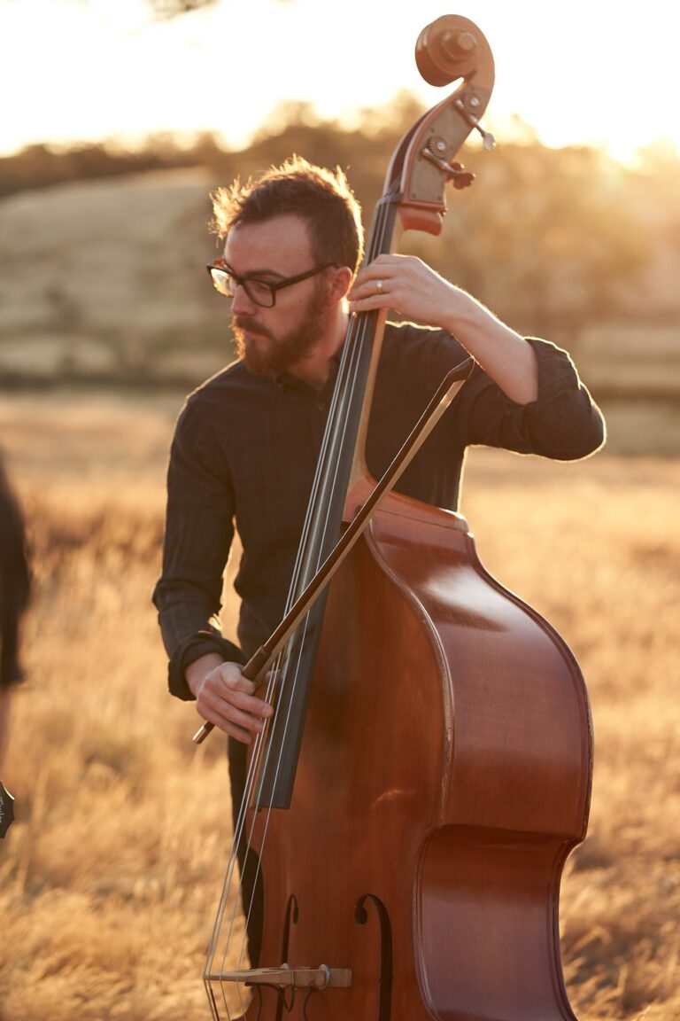 Jamie on double bass in golden evening light, Tobi Tobi