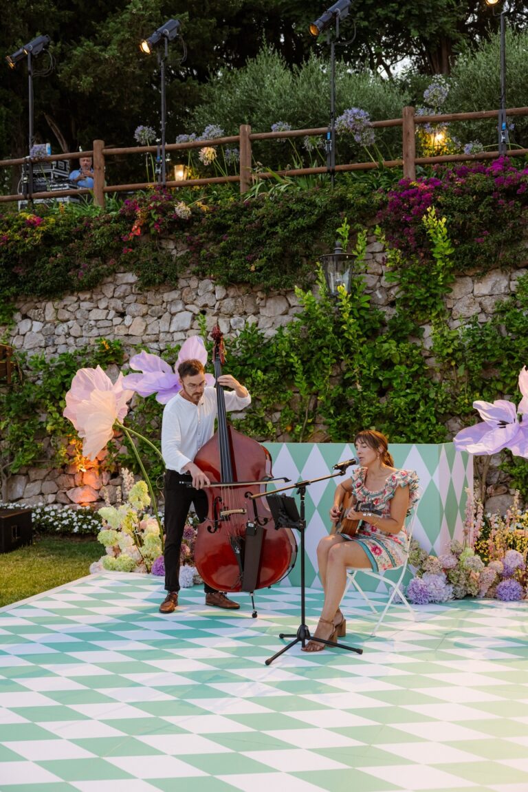 Duo performing on a checked dance floor among wildflower decor, Tobi Tobi
