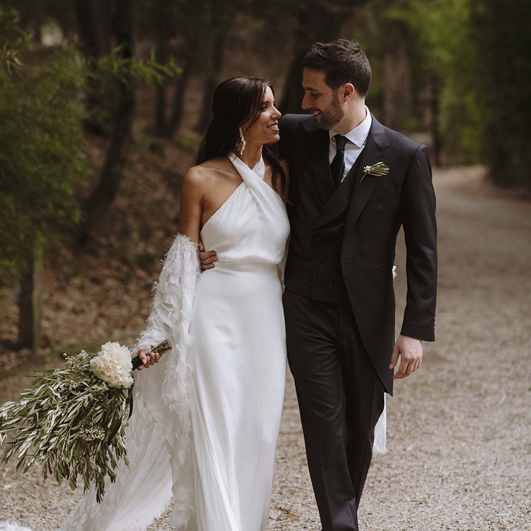 A couple walking together along a gravel track through the woods, Torre Sever