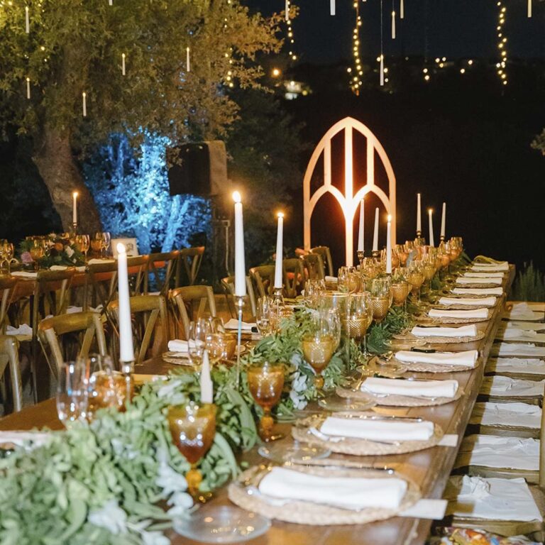 Candlelit outdoor banquet table at night, Torre Sever
