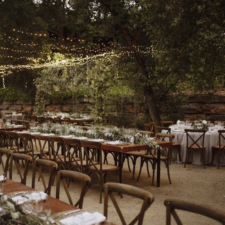Long outdoor tables under a canopy of lights, Torre Sever