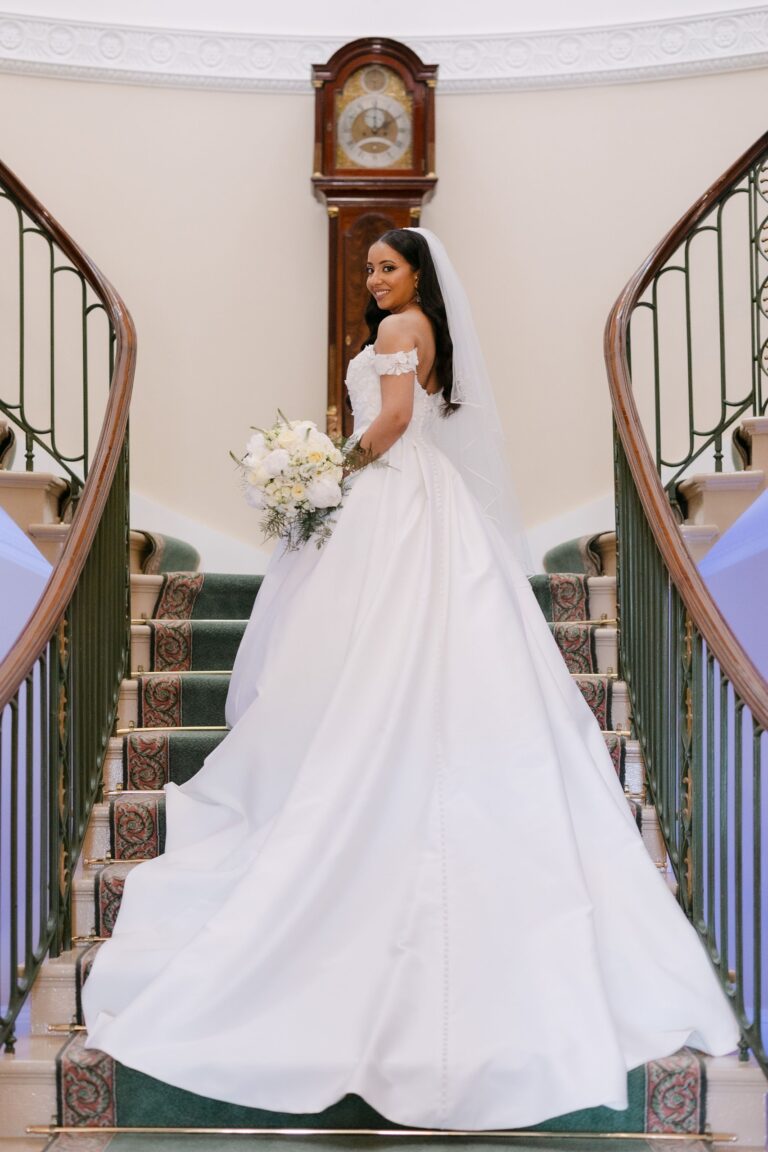 A bride on the twin staircase below the longcase clock, Trinity House on Tower Hill