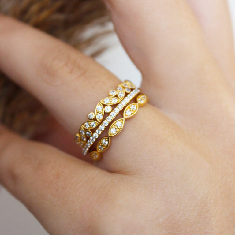 A stack of gold clad leaf and marquise bands worn together, Tru-Diamonds™