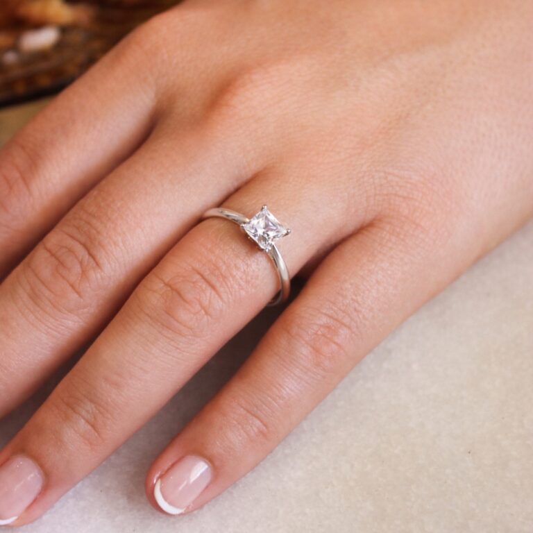 A princess cut solitaire on the hand, Tru-Diamonds™