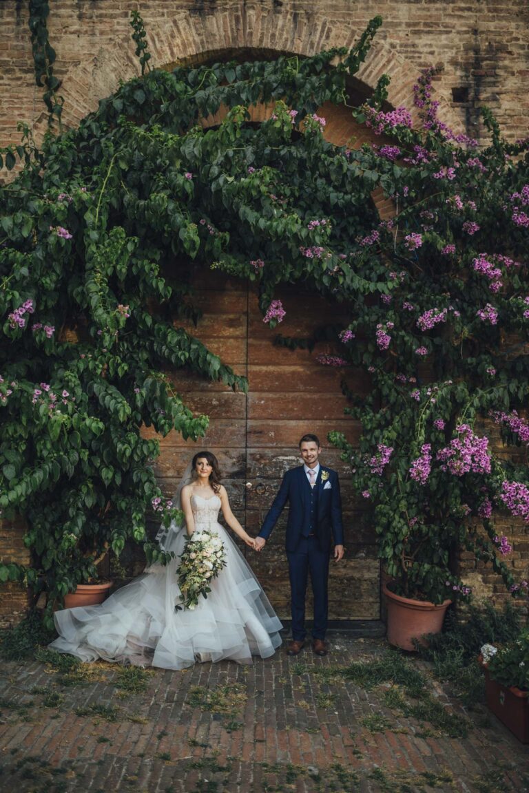 The couple under a brick archway hung with bougainvillea, Tuscan DMC