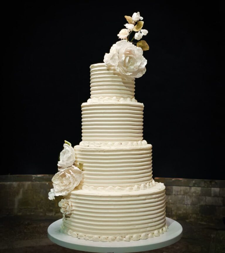 Four-tier buttercream wedding cake with piped pearl borders and handcrafted sugar roses at Castello Il Palagio in Tuscany, Italy., Tuscan Wedding Cakes