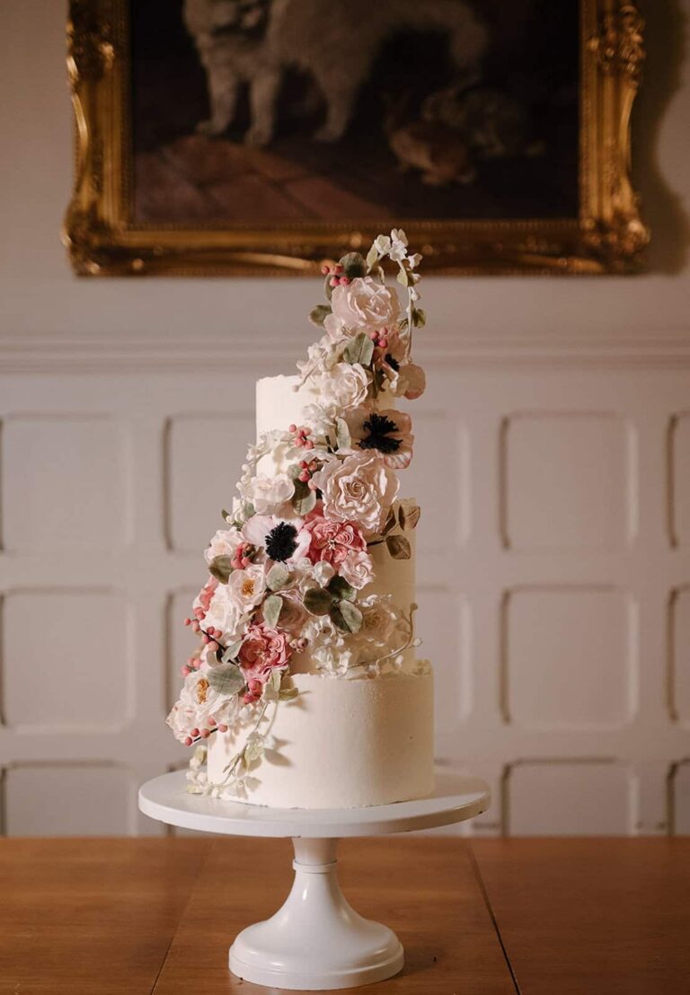Buttercream wedding cake with cascading handcrafted sugar flowers at Villa Fontanelle in Florence, Italy., Tuscan Wedding Cakes