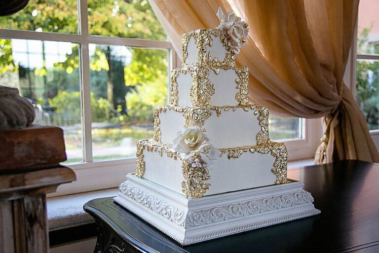 Square four tier wedding cake with gold bas-relief detail at Borgo Santo Pietro, Tuscany, Tuscan Wedding Cakes