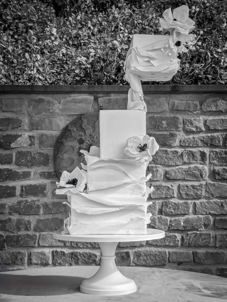 Modern white sculptural wedding cake with dramatic ruffled tiers and white sugar flowers at Collegio alla Querce in Florence, Italy., Tuscan Wedding Cakes